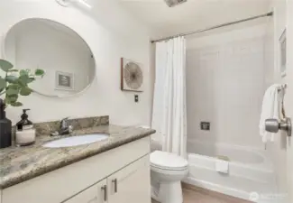 Second bathroom with granite countertop.