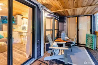 Close-up of covered deck with seating and access to interior