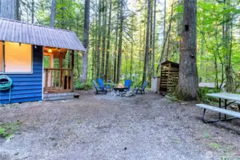 Outdoor gathering area with picnic table and fire pit