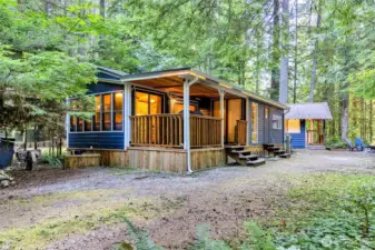 Angled exterior view highlighting covered porch and lot space