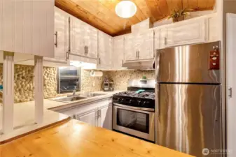 Kitchen workspace with cabinetry, backsplash, and counter space