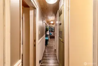 Hallway connecting living space to bedrooms and bath