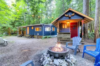 Evening-style exterior with fire pit and cabin ambiance