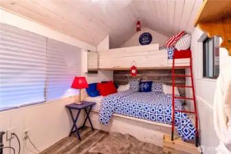 Shed interior with bunk beds and additional sleeping space