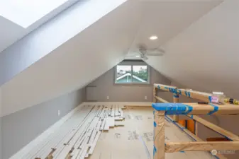 Loft area with ceiling fan