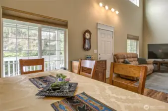 The dinning room overlooks the beautiful front deck and woody area.