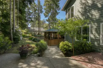 Hot tub is set into the garden oasis behind the home.