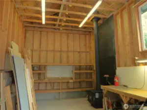 Looking inside the RV shop, you will find storage and a wood burning stove.