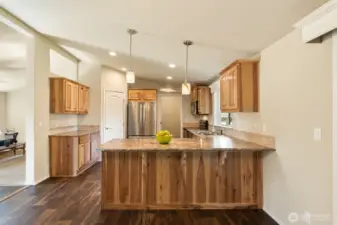 Eating bar in the kitchen, stainless appliances, & knotty pine cabinets.  Walk in pantry & lots of counter space!