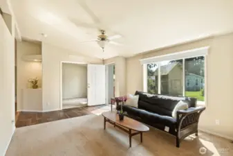 Formal living room with art niche, and french doors into the den.