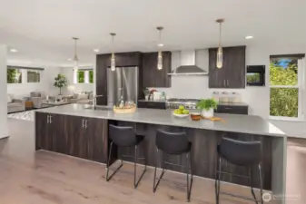 An oversized waterfall kitchen island welcomes you to this entertainers dream of a kitchen.