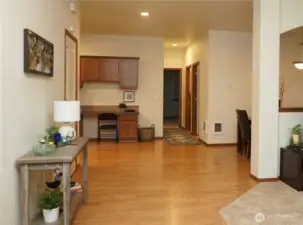 Just inside the door you have the living room to the right, primary bedroom to the left and kitchen straight ahead.