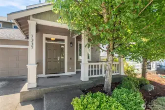 Set on your front porch shaded by the mature tree