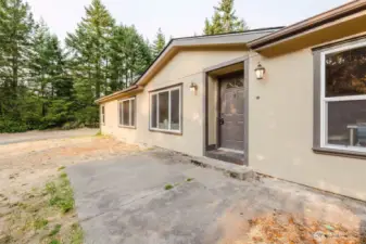 Front entry view with welcoming walkway and natural setting.