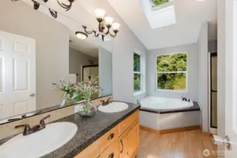 Primary bath with dual sinks and soaking tub.