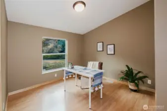 Secondary bedroom with neutral paint and laminate floors.