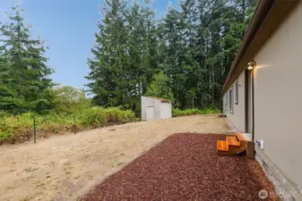 Side yard with pathway and low-maintenance landscaping.