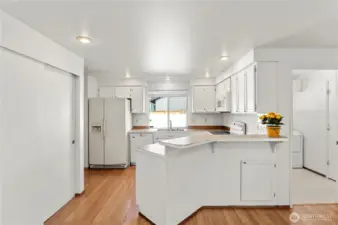 Kitchen w/pantry and laminate flooring.