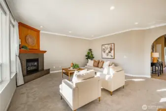 Living Room with new carpet, gas FP, 9' ceiling and lots of natural light