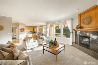 Living Room with new carpet, gas FP, 9' ceiling and lots of natural light