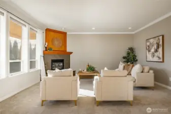 Living Room with new carpet, gas FP, 9' ceiling and lots of natural light