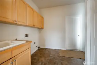 Spacious laundry room with wash sink and large closet