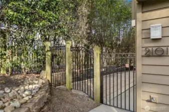 Gated entry leads to a private patio, providing privacy and simultaneously welcoming transition from the street to home.