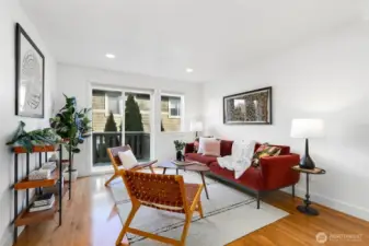 First of two living areas on the main level with eastern-facing sliding doors that open to a spacious balcony, blending indoor comfort with outdoor access.