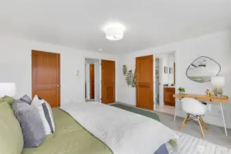 Primary bedroom with large, walk-in closet (left door pictured here) and ensuite bath for added privacy and convenience.