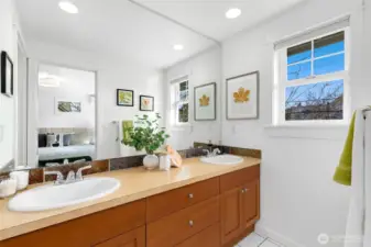 Primary ensuite bath featuring a spacious double-sink vanity with generous counter and cabinet space, plus a separate door to the shower and toilet for added privacy.