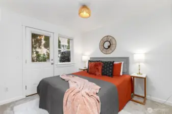 Lower-level bedroom with private access off patio and ensuite bath — ideal for guests, roommates, or flexible living arrangements.