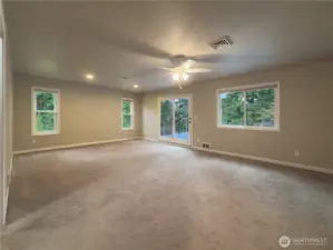 Primary suite with slider out to the deck that overlooks the private backyard.