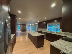 Beautiful chefs kitchen with full height cabinets, granite slab countertops, giant island & HIDDEN walk in pantry!