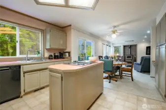 Kitchen with eating space opens to family room with deck access