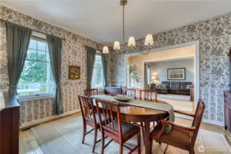 View of dining room next to front entrance and looking into Family room.