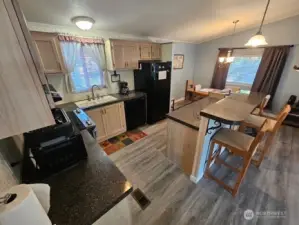 Plenty of counter space and a great bar with stools.