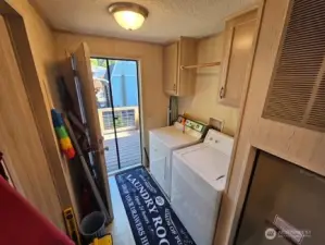 The utility room has a door to the back deck.  Washer and dryer stay!