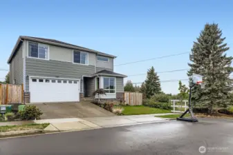 Street view of home with attached garage and driveway.