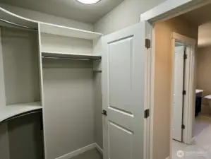 Primary bedroom walk-in closet with ample storage and organization space.