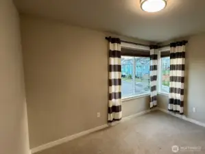 The fourth upstairs bedroom is a corner space with commanding views of the neighborhood.