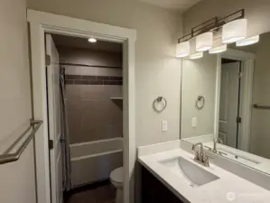 A fully compartmentalized hall bath serves all three secondary bedrooms.