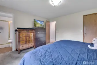 Master bedroom bathroom to the left and walk in closet to the right in the photo