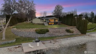 Private shoreline featuring concrete bulkhead and dock setup