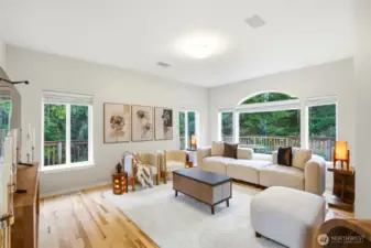New gleaming hardwood floors bring warmth and elegance to the living room, elevating the space with a fresh, timeless feel. Natural light reflects beautifully across the flooring, creating a bright and inviting atmosphere throughout the day.