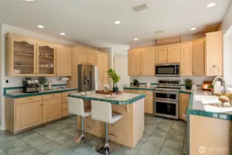 A spacious island with built-in wine fridge makes entertaining effortless and inviting.