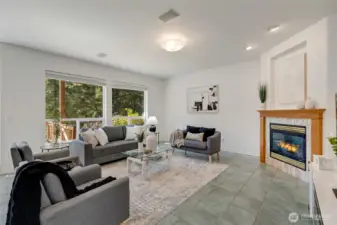 Large windows bring the outdoors in, reinforcing the home’s peaceful setting. This is where daily life comfortably unfolds.