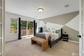 Enter the primary suite through elegant French doors into a true private retreat. Wake up to tranquil wooded views and step onto your own balcony for fresh morning air.