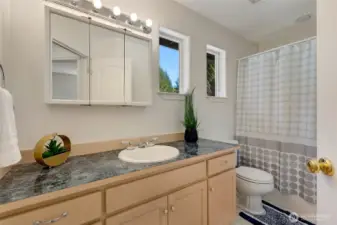 The upper-level full bathroom combines style and functionality, serving both family and guests with ease.