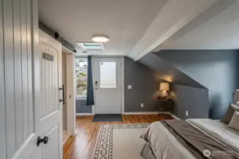 Virtually staged rear room with exterior entrance on upper level