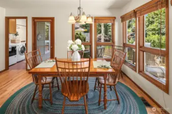 Believe it or not, this is the seller's favorite room in the whole house!  This is the informal eating room that is adjacent to the kitchen.  Surrounded by windows, this country cute space is right out of Homes and Land!